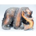 A large carved wood group of a bear and a fish40cm