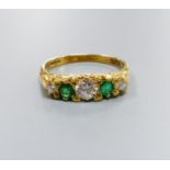 A modern Victorian style 18ct gold, three stone diamond and two stone emerald set half hoop ring,