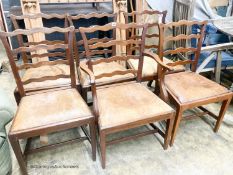 A set of six George III mahogany ladderback dining chairs with leather drop in seats (one with