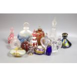 A collection of various glass scent bottles including a Lalique flower scent bottle and Bohemian