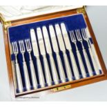 A cased set of twelve pairs of George V silver bladed fruit eaters (weighted handles), Tessiers