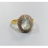 An 18ct gold, aquamarine and diamond cluster ring, size L, gross weight 3.9 grams.