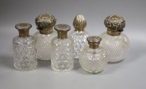 Six assorted silver topped glass scent bottles, including a pair by Chares Stuart Harris, London,