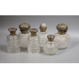 Six assorted silver topped glass scent bottles, including a pair by Chares Stuart Harris, London,