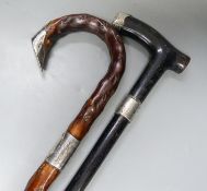 Two Victorian silver mounted walking sticks, longest 92.5 cm