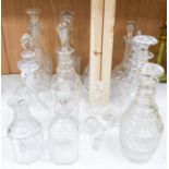 A collection of thirteen cut glass decanters