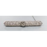 A modern Belle Epoque style pierced 750 white metal and diamond set bar brooch, 58mm, gross weight