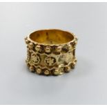 A yellow gold bead and flower-decorated ring (indistinct hallmarks), size N, 8.4 grams.