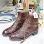 A pair of tan leather boots with trees