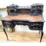 A late Victorian carved mahogany serpentine-shaped writing desk, length 106cm, depth 54cm, height