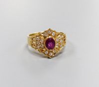 A modern 14ct gold, single stone ruby and diamond chip cluster set dress ring, size O, gross 4.1