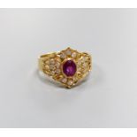 A modern 14ct gold, single stone ruby and diamond chip cluster set dress ring, size O, gross 4.1