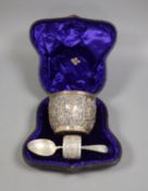 A cased late Victorian embossed silver christening bowl, spoon and napkin ring, Aird & Thomson,