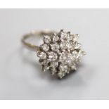 A modern 18ct white gold and diamond set flower head cluster ring, size M, gross weight 6.6 grams.