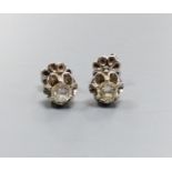 A pair of white metal and solitaire diamond set ear studs, each stone approx. 0.20ct, gross weight