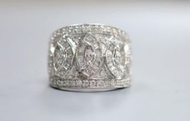 A 14ct white gold, round and trapeze cut diamond set cluster dress ring, size N/O, gross weight 8.6