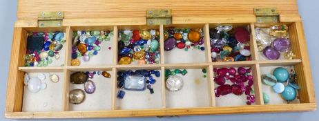 A quantity of unmounted gemstones, housed in a wooden box, including opal, opal doublet,