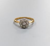 An 18ct & plat, circular diamond cluster set ring, size M/N, gross weight 2.5 grams.