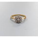 An 18ct & plat, circular diamond cluster set ring, size M/N, gross weight 2.5 grams.