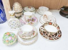 A group of Dresden and Continental porcelain cups and saucers boxes and covers and a scent bottle,