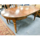 An Edwardian mahogany oval extending dining table, length 180cm extended with one spare leaf, width