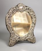 An Edwardian repousse silver mounted easel mirror, with heart shaped plate, William Comyns, London,