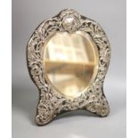 An Edwardian repousse silver mounted easel mirror, with heart shaped plate, William Comyns, London,