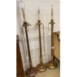 A set of three gilt carved wood lamp standards, height excluding fittings 135cm