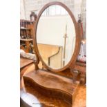 An Edwardian George III style mahogany serpentine toilet mirror, width 61cm, height 90cm