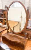 An Edwardian George III style mahogany serpentine toilet mirror, width 61cm, height 90cm