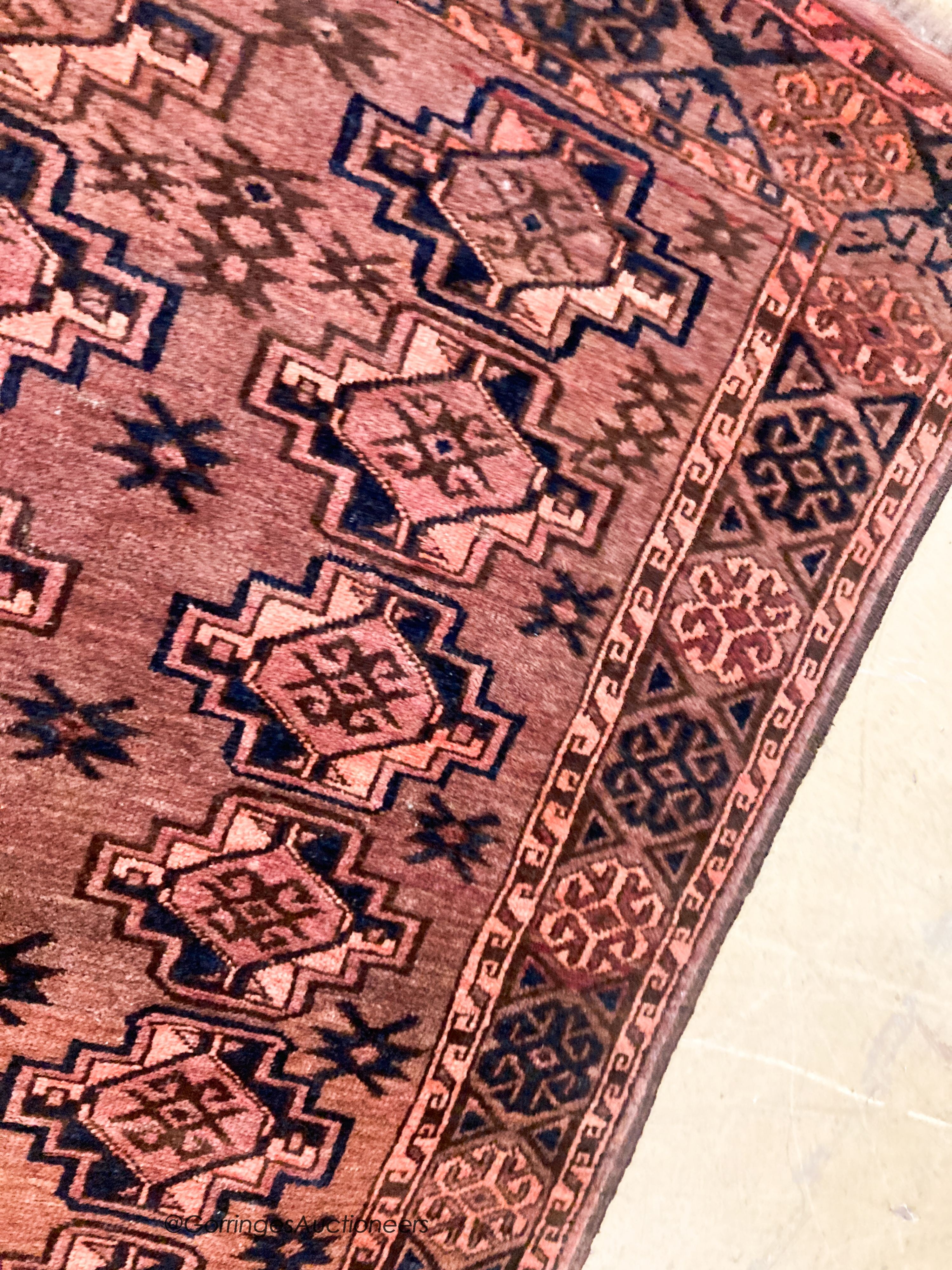A Bokhara burgundy ground rug, 190 x 105cm - Image 3 of 5