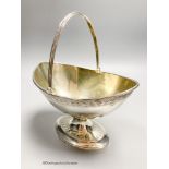 A George III silver boat shaped pedestal sugar basket, James Young, London, 1790, width 17.3cm, 10.