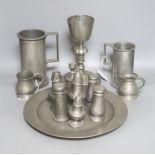 Seven pewter salt or pepper pots, a goblet, 23.5cm, four measures and a plate