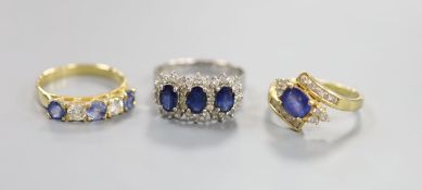 A modern 7560 white metal, sapphire and diamond set triple cluster ring, size Q/R and two other