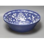 A large Chinese blue and white porcelain basin, lightly relief moulded with plants, 40cm