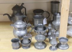 Eighteen items of 18th and 19th century pewter, including lidded jugs, measures, goblets, salt and