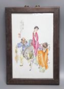 A Chinese framed poreclain plaque, painted with figures and script, height 44cm incl. frame