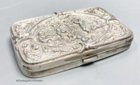 A late Victorian embossed silver shaped rectangular cigarette case, with mirrored interior,