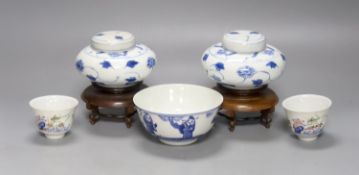 A pair of Chinese blue and white jars and covers, 6.5cm, on wood stands, a Chinese blue and white