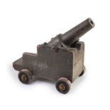 A cast iron starting cannon, probably 18th/19th century,on a wooden carriage with cast iron wheelsH