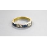 A modern 18ct gold and channel set six stone sapphire and four stone diamond half hoop ring, size