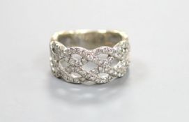 A modern 14k white metal and diamond chip set interwoven dress ring, size M, gross weight 6.5