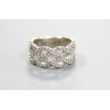 A modern 14k white metal and diamond chip set interwoven dress ring, size M, gross weight 6.5