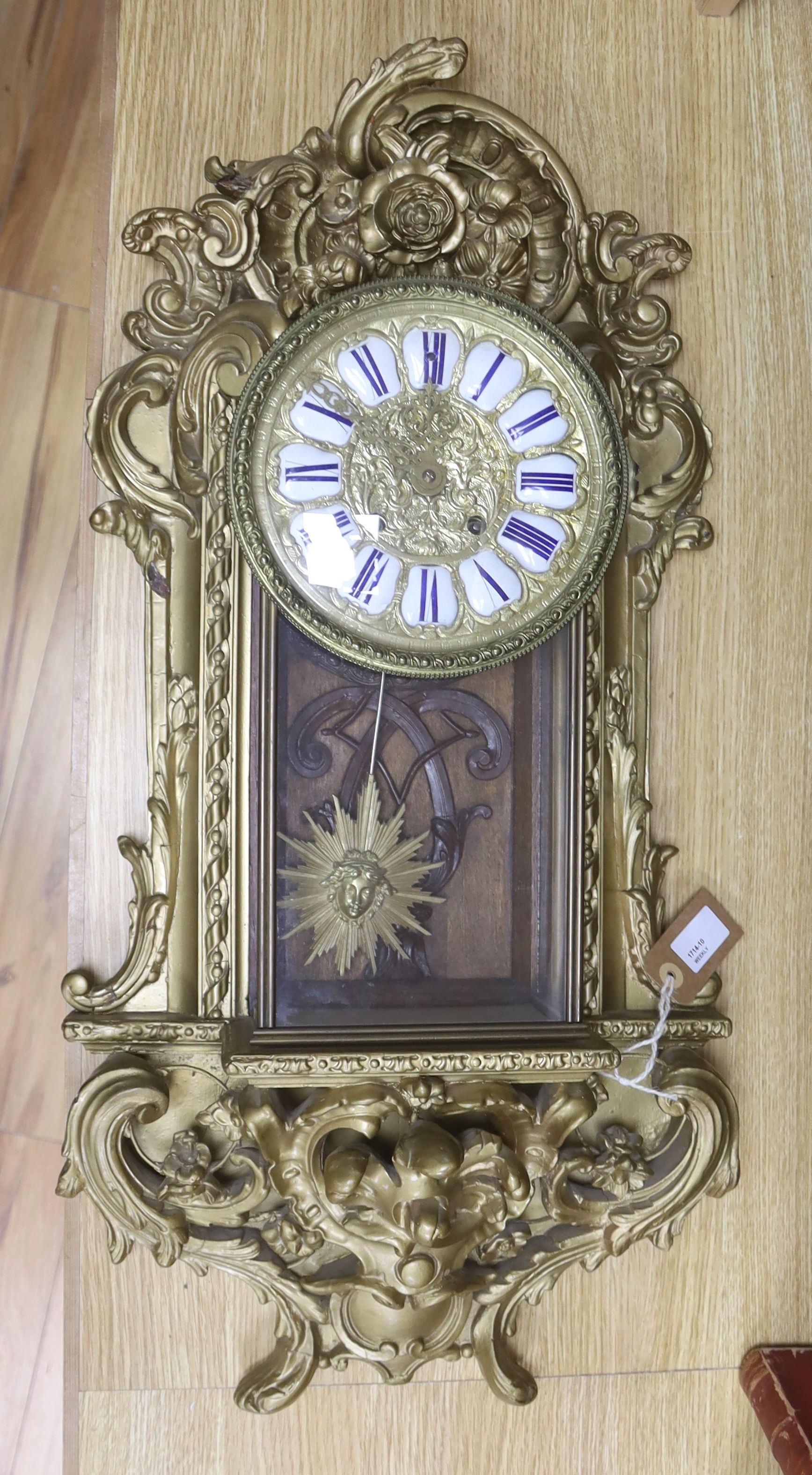 A 19th century French gilt and composition wall clock, with scrolled acanthus carving and '