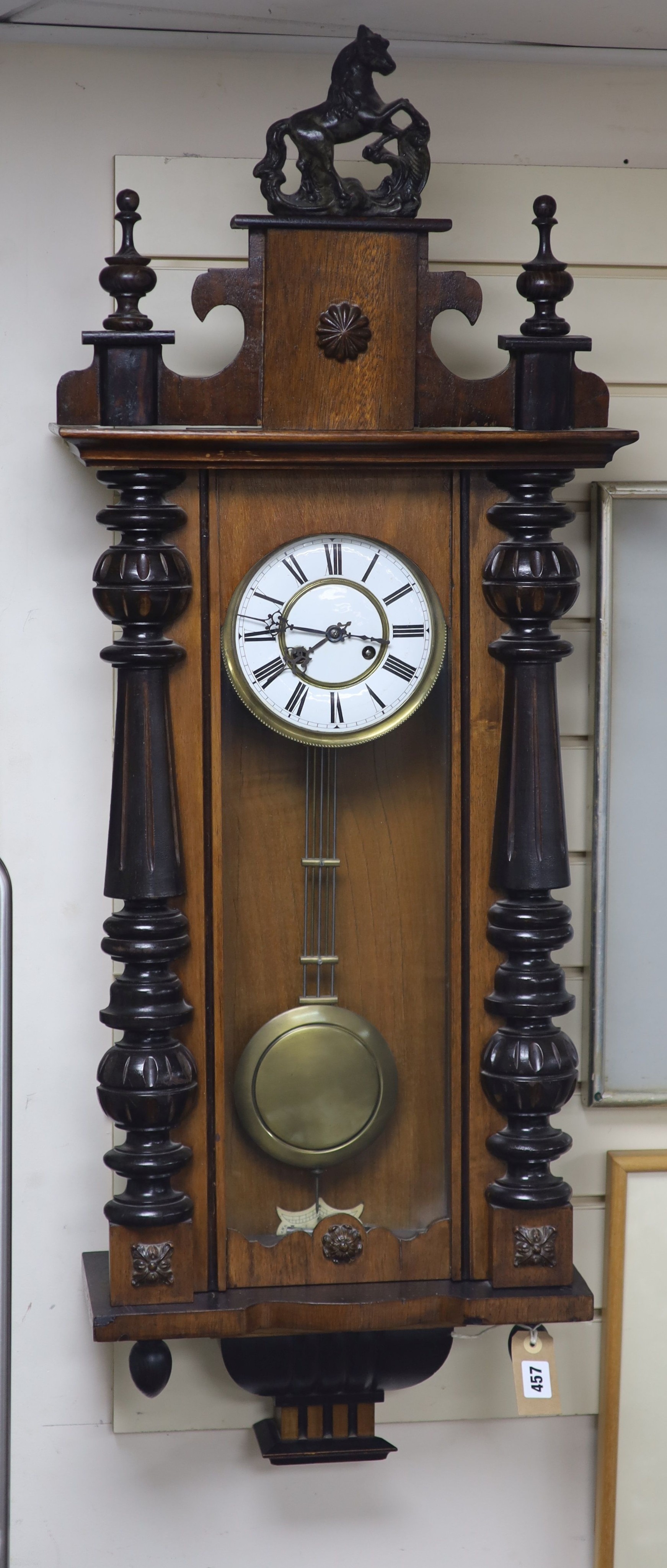 A 19th century Continental regulator in architectural walnut case, with key and gridiron pendulum,