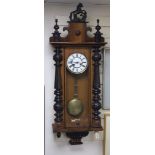 A 19th century Continental regulator in architectural walnut case, with key and gridiron pendulum,