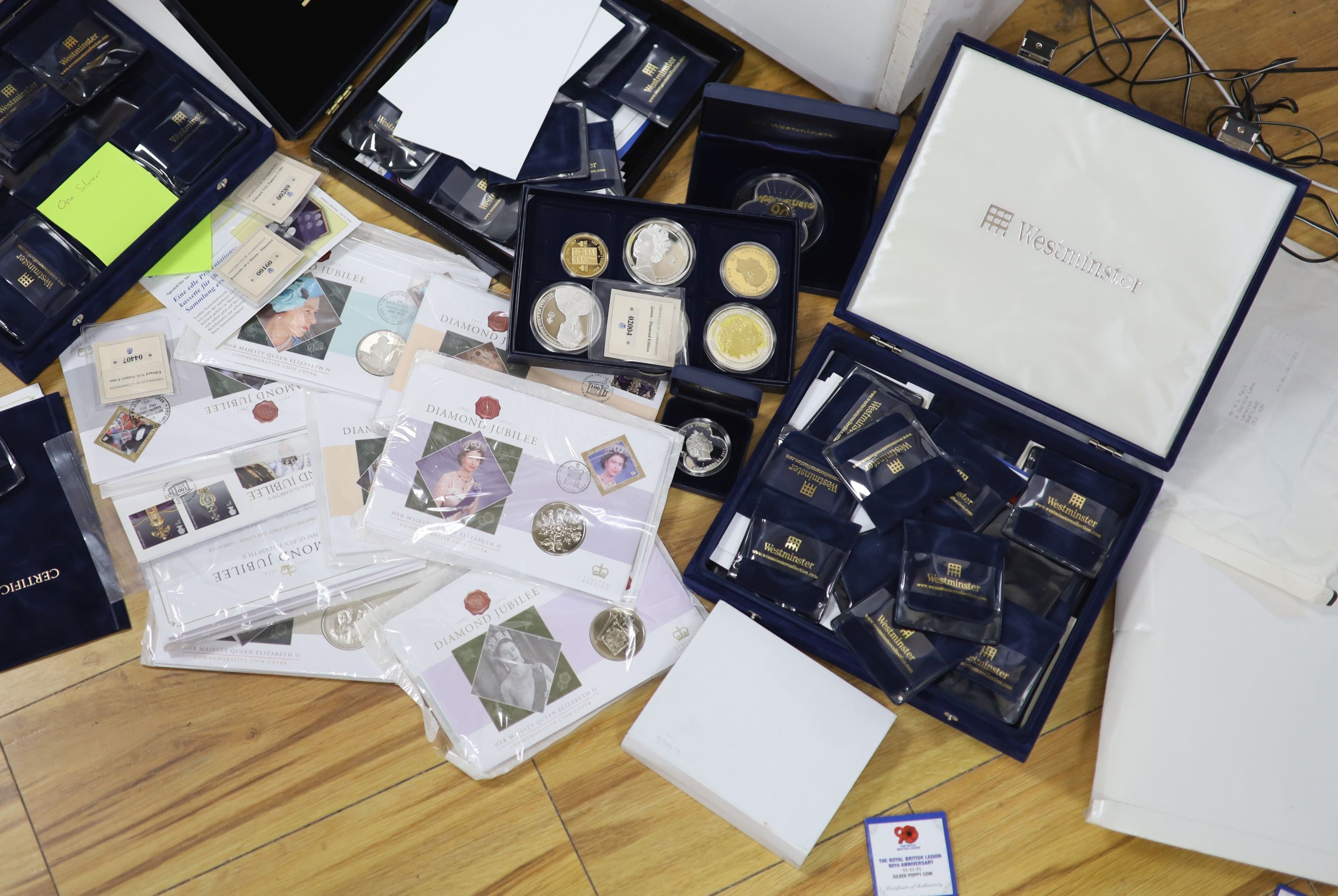 A collection of Westminster & Royal Mint QEII commemorative coins, some silver issues