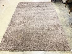 A contemporary brown shag pile carpet, 300 x 200cm