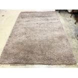 A contemporary brown shag pile carpet, 300 x 200cm