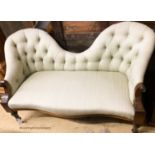 A Victorian mahogany double spoon back settee upholstered in buttoned green fabric, width 130cm,